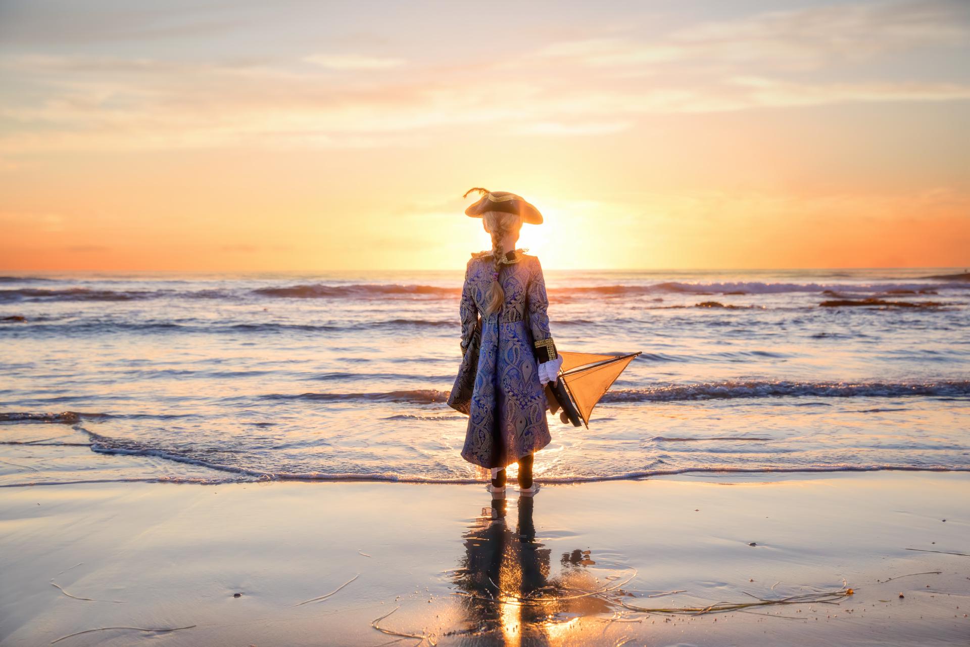 Pirate watching the sunrise holding a toy boat