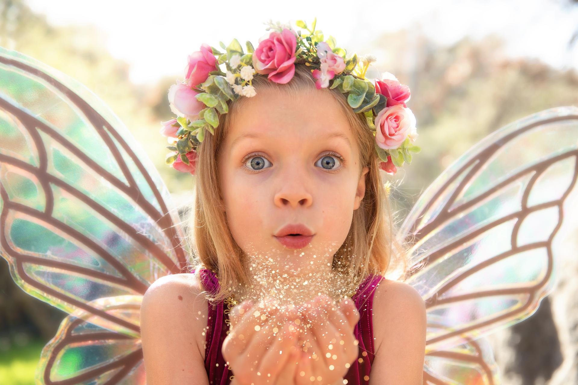 Little girl blowing fairy dust